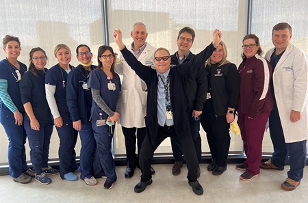HUP unit secretary Veronica Elena with Todd Hecht, MD, Max Itkin, MD, and Elena’s colleagues from the cardiac intensive care unit.